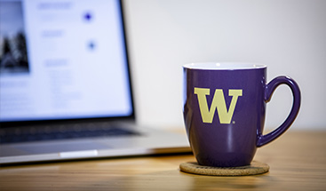 purple UW mug and laptop
